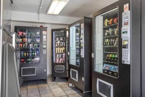 A row of vending machines with various snacks and drinks. - 2 Full Beds | Micfridge (Phoenix)