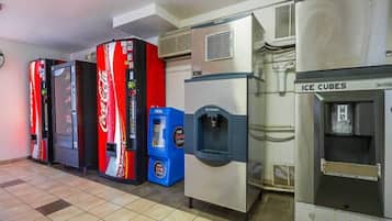 A row of vending machines including Coca-Cola, free drinks, and an ice cube dispenser.