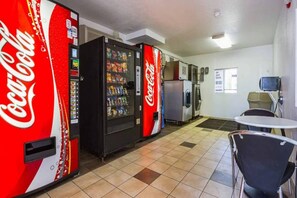 A room with vending machines, a refrigerator, a microwave, and a small table with chairs. - 2 Full Beds | Mini Fridge (MESA)