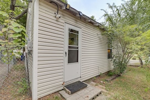 A single-story house with a front door, a small window, and a visible electrical box on the side. - Cozy, Convenient! Tulsa Stay Near Dtwn & Route 66 (Tulsa)