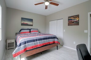 A bedroom with a bed, a nightstand, a ceiling fan, and two wall-mounted paintings. - Townhome 1 Mi to Midtown & Botanical Gardens! (Tucson)