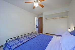 A bedroom with a bed, a ceiling fan, a door, and a wall-mounted shelf. - 12 Mi to JBLM: Olympia-Area Escape (Lacey)