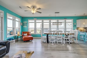 A bright kitchen with a dining area, large windows, and a ceiling fan. - Stroll to Beach! Family Surf City Home w/ Views (Surf City)