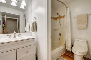 A bathroom with a white vanity, a shower with a glass door, and a toilet. - Incline Village Condo Near Lake Tahoe Adventures (Incline Village)