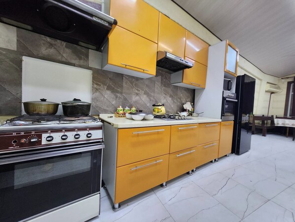 A kitchen with a stove, oven, and cabinets.