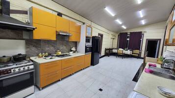 A kitchen with a stove, oven, microwave, and cabinets.