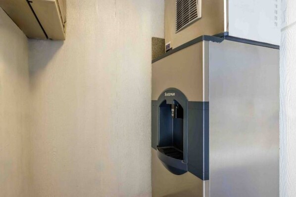 A corner of a building with a wall-mounted air conditioning unit labeled 'Scotsman' and a vent on the upper right side.