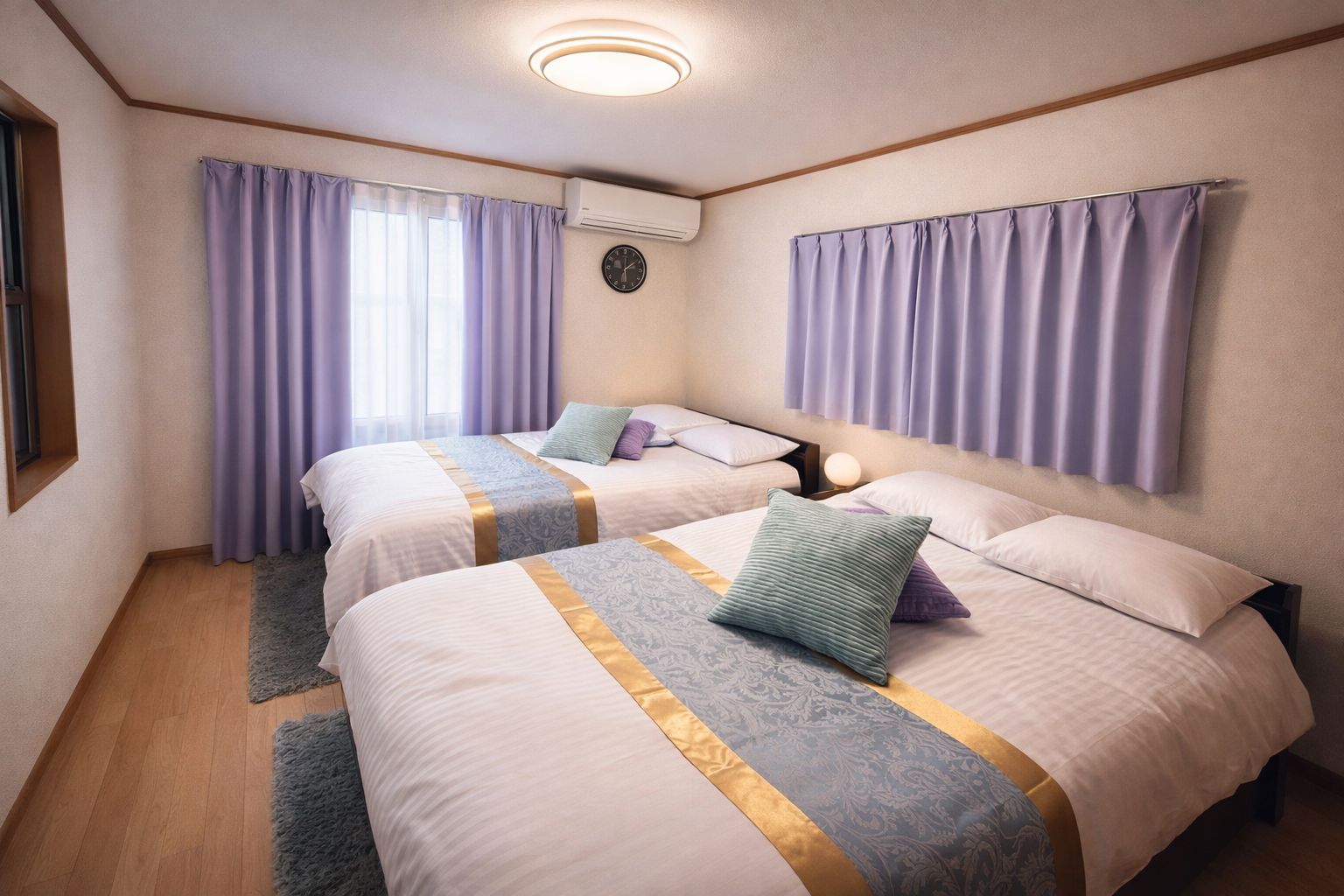 A hotel room with two beds, a clock on the wall, and a window with curtains.