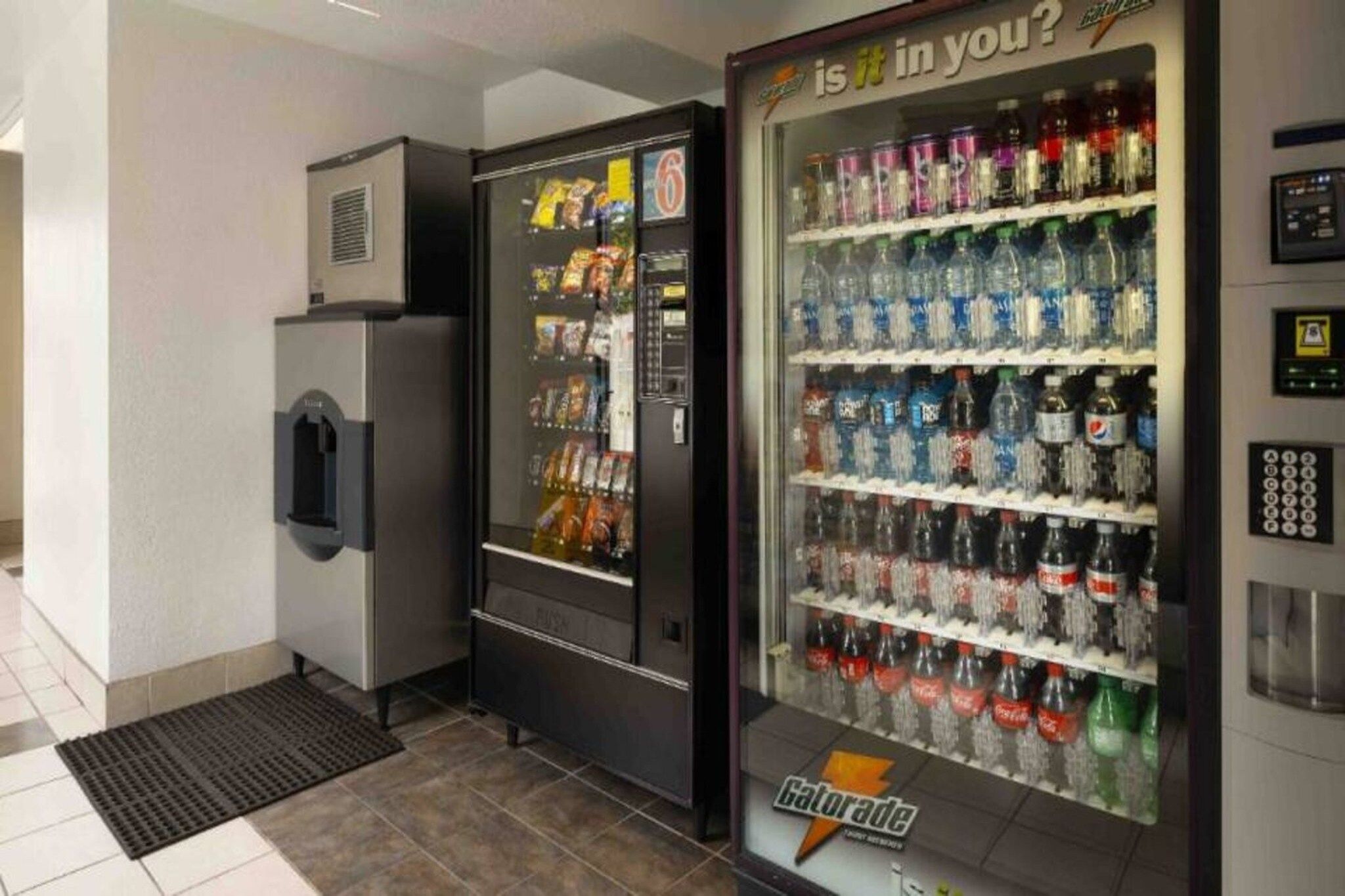 A vending machine area with a selection of snacks and beverages.