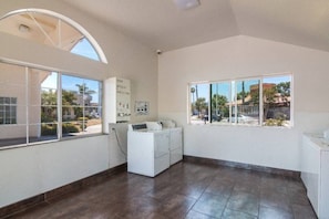 A laundry room with a washing machine, a dryer, and a large window with a view of the outside. - 1 Queen Bed | Smoking, Micfridge (South El Monte)