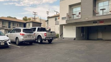A parking lot with a white SUV and a pickup truck.