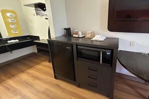 A compact kitchenette with a microwave, a small refrigerator, and a sink. - 1 Queen Bed | Suite, Smoking, Micfridge (Riverside)