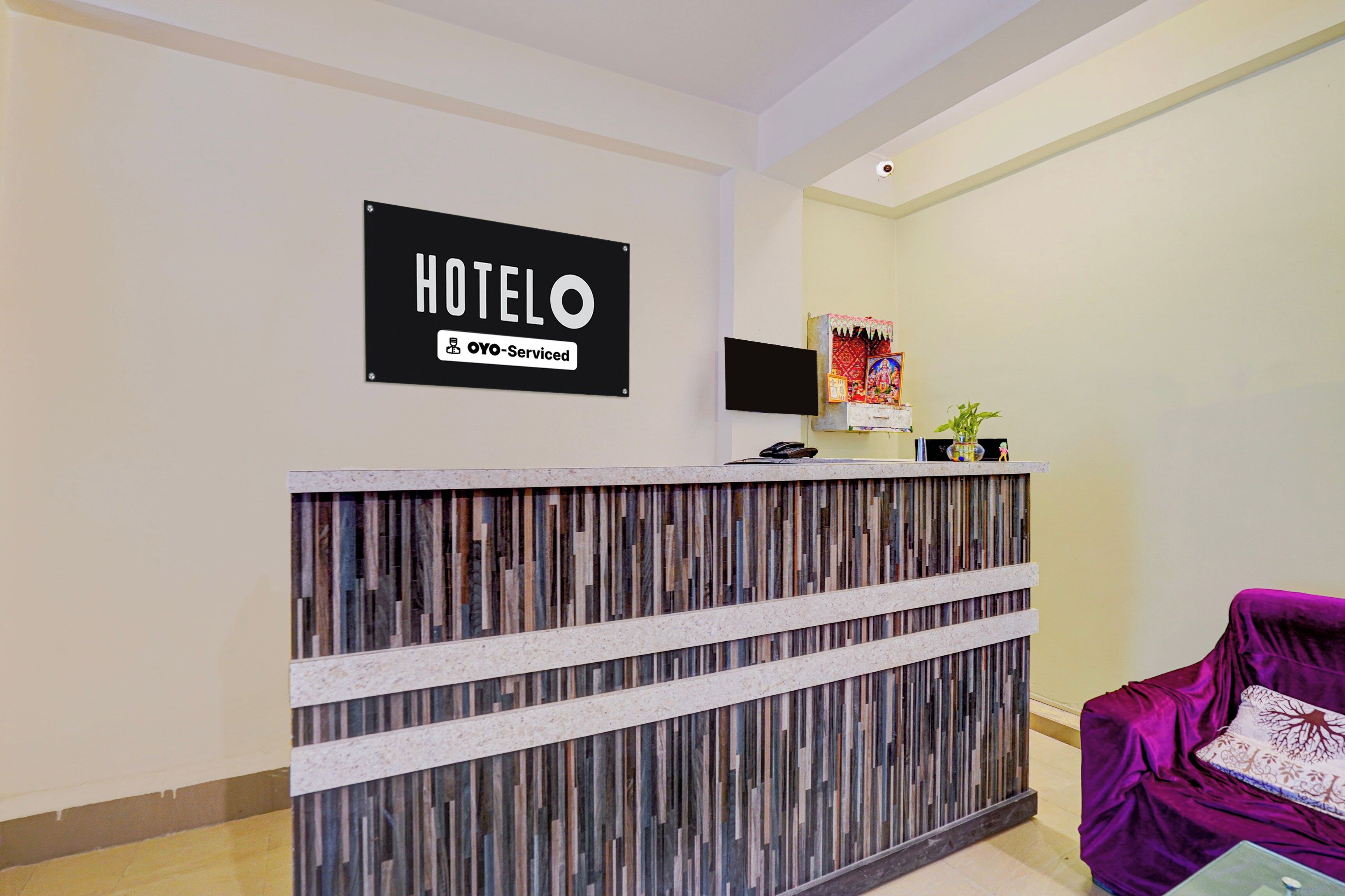 A hotel reception desk with a sign that reads 'HOTELO' and 'YOY-Serviced'.