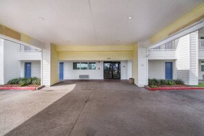 A building with a flat roof, a central entrance with a glass door, and a number '6301' above the door.