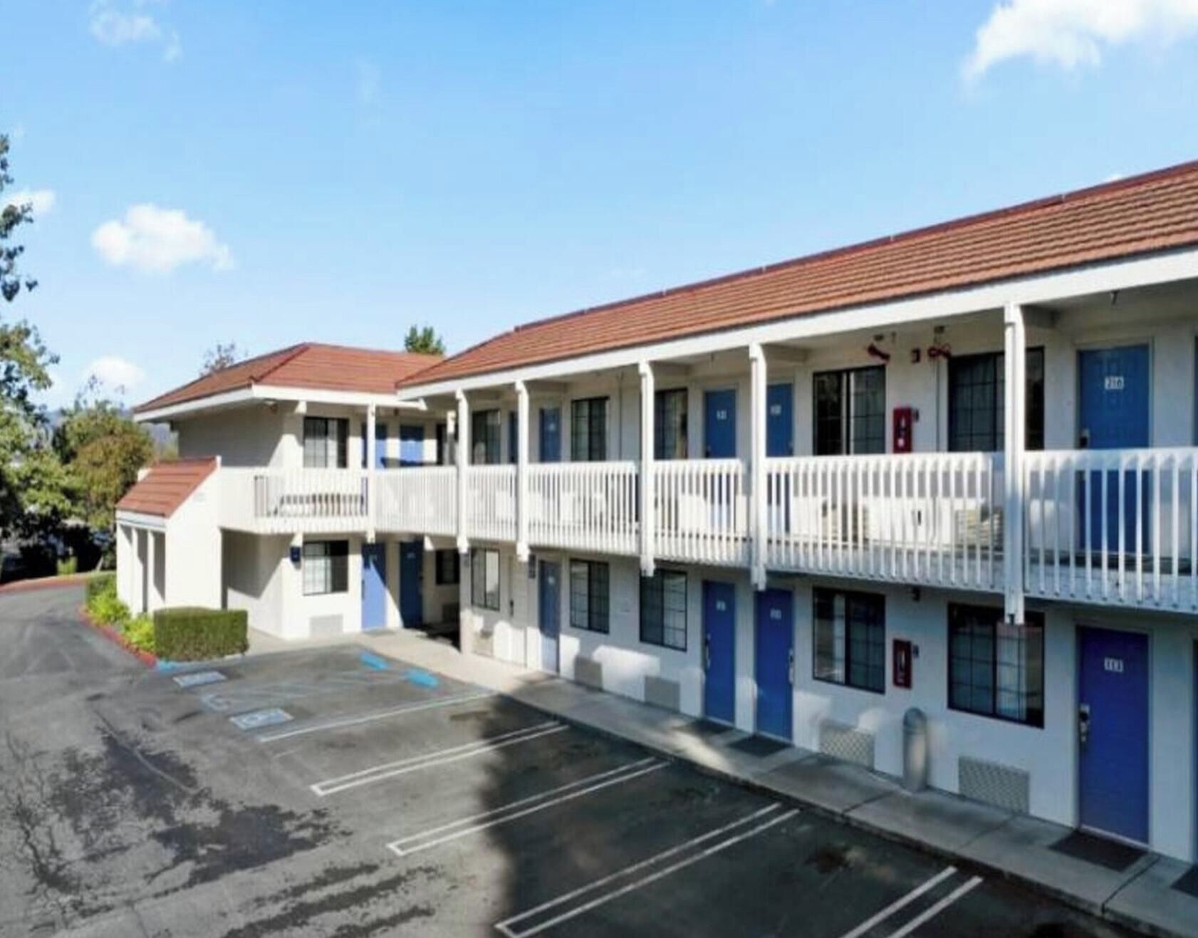 Un motel doté de nombreuses chambres, d’un parking et offrant une vue sur un ciel dégagé.