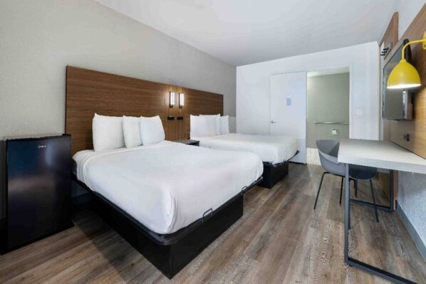 A hotel room with two beds, a desk, and a small kitchenette. - 2 Queen Beds | Non-Smoking (Santa Ana)