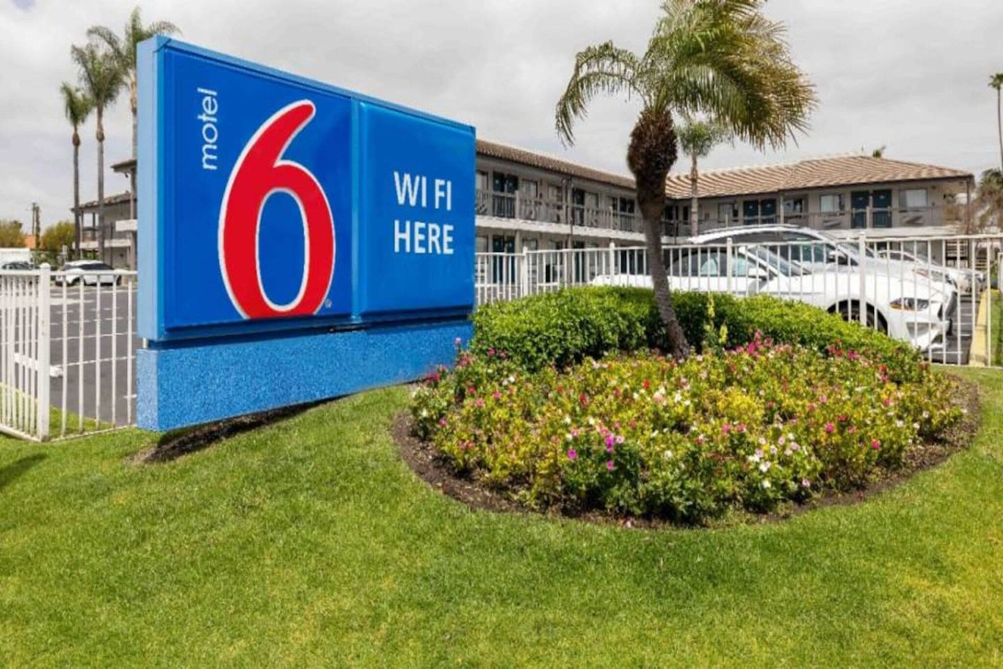 A motel sign with a number 6 and 'WiFi Here' indicating the presence of internet connectivity.