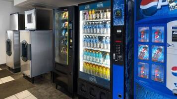 A row of vending machines including a Pepsi dispenser and a water cooler.