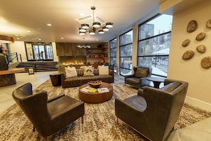 A modern living room with leather sofas, a coffee table, and a fireplace. - King Guest Room with Wet Bar | Pet-Friendly (Heber City)