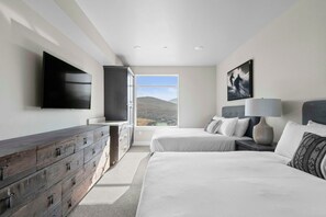 A bedroom with a bed, a dresser, a TV, and a window with a view of hills. - Pet-Friendly Room Nr Park City w/ Mountain Views (Heber City)