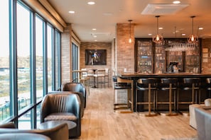 A bar area with a high ceiling, exposed brick walls, and a view through large windows. - Pet-Friendly Room Nr Park City w/ Mountain Views (Heber City)