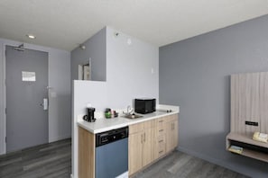 A compact kitchen with a dishwasher, a microwave, and a sink. - 2 Queen Beds|Mobility|Tub|Nsmk|Micfridg (Lake Havasu City)
