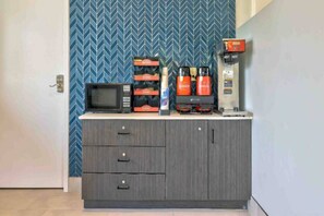 A kitchenette with a microwave, coffee maker, and storage cabinets. - 2 Queen Beds | Non-Smoking (Bethel)