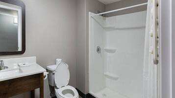 A bathroom with a toilet, sink, and shower.