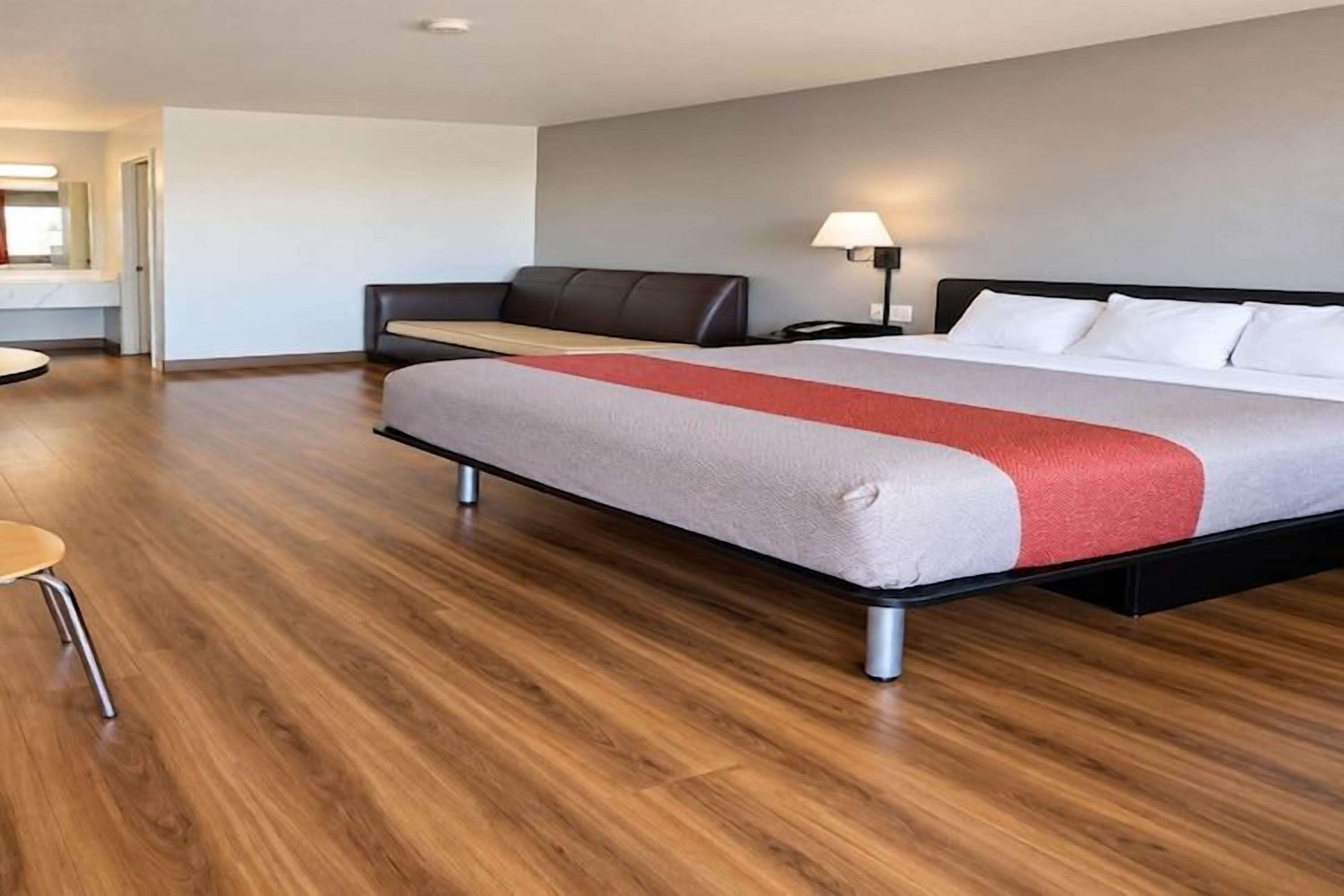 Een moderne hotelkamer met een groot bed, een bureau en een stoel.