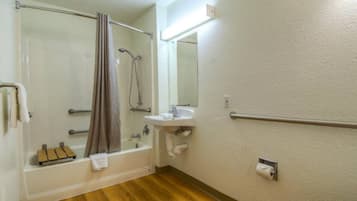 A bathroom with a bathtub, a shower, a sink, and a toilet.