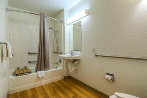 A bathroom with a bathtub, a shower, a sink, and a toilet. - 2 Full Beds | San Diego (Chula Vista)