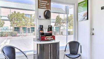 A coffee station with a sign indicating no morning charge for coffee.