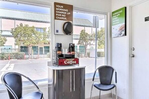 A coffee station with a sign indicating no morning charge for coffee. - Spacious 1  Queen Bed|Free Parking (Campbell)