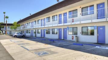 A motel with multiple rooms, a parking lot, and a manager's office.