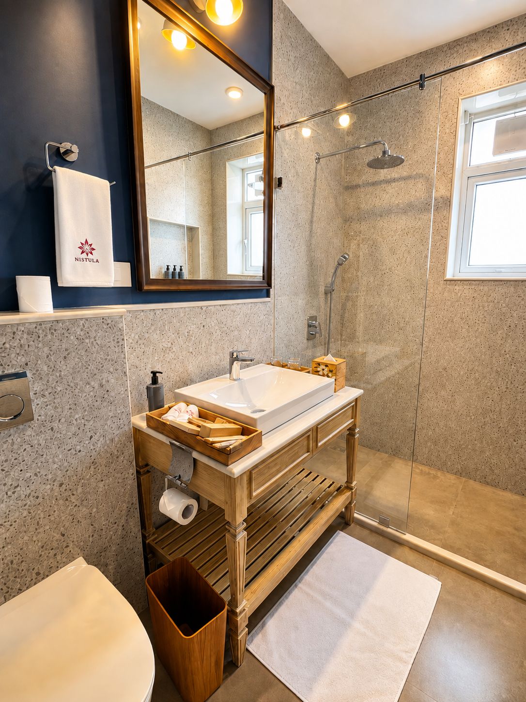 A modern bathroom with a freestanding sink, a large mirror, a shower enclosure, and a towel rack.