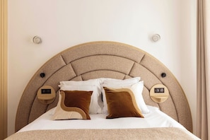 A bed with a headboard, pillows, and bedside controls. - A Real Paris Experience : Walk to Montmartre ! (Paris)