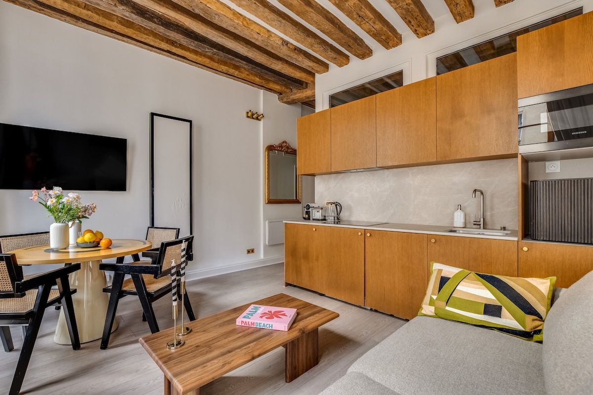 A modern living room with a wooden dining table, a sofa, and a coffee table.