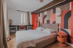 Une chambre moderne avec un lit, une table de chevet et un bureau avec des chaises.