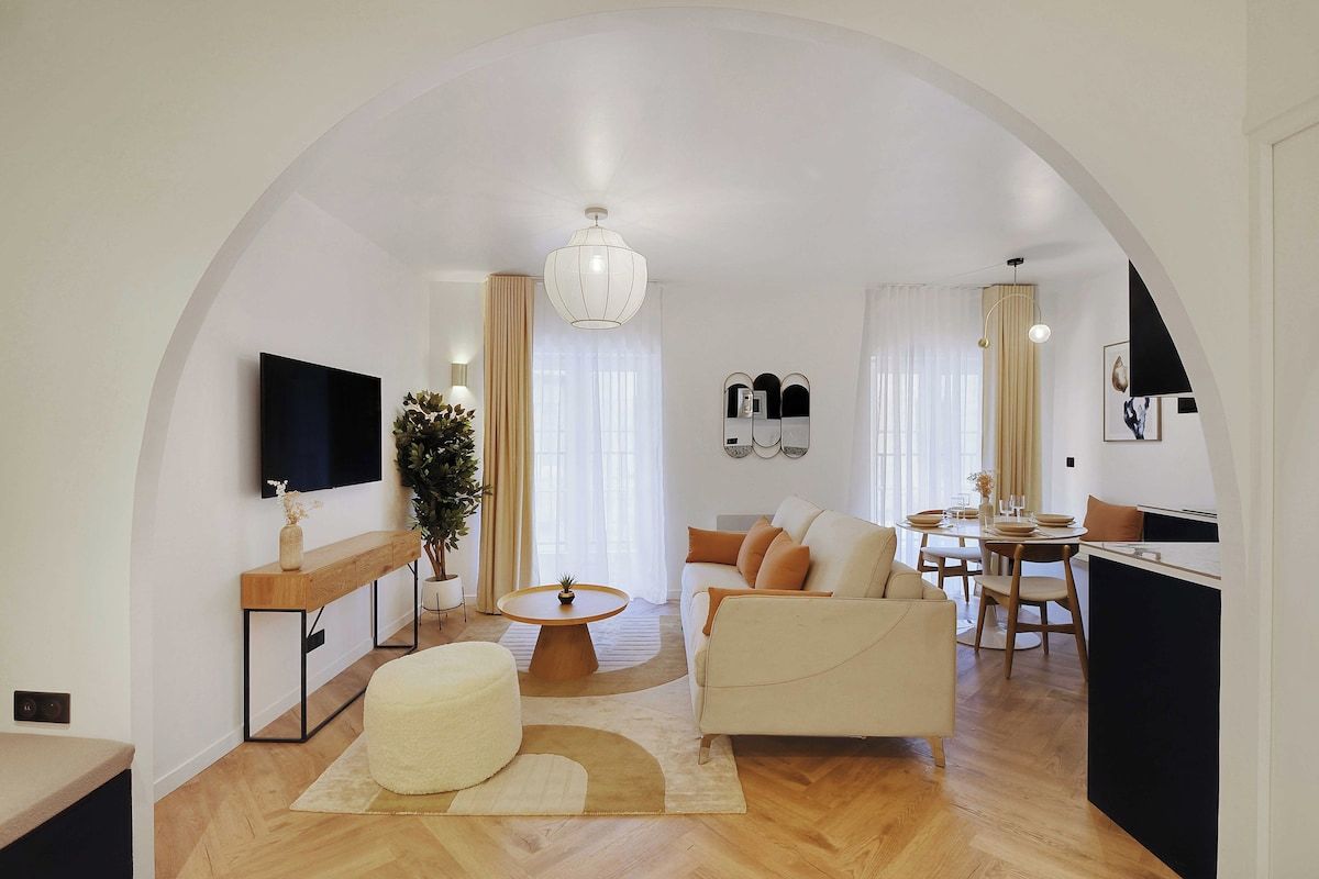 A modern living room with a sofa, coffee table, and TV.