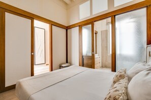 A bedroom with a bed, a small stool, and a mirror. - Location, location, location - 1BR near Louvre (Paris)