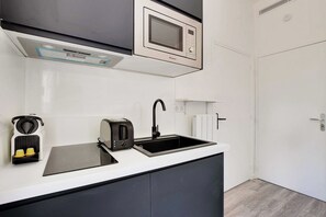 Eine moderne Küche mit integriertem Mikrowellenherd, Toaster und Induktionskochfeld.