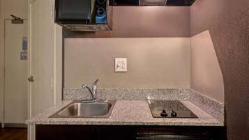 A kitchen with granite countertops, stainless steel sink, and a dishwasher.