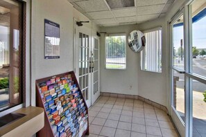 A corner room with a tiled floor, a bulletin board with various items, and a window with blinds. - 2 Queen Beds | NSMK, Micfridge (Sacramento CA)