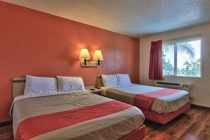 A hotel room with two beds, a window with curtains, and a wall-mounted lamp. - 2 Queen Beds | NSMK, Micfridge (Sacramento CA)