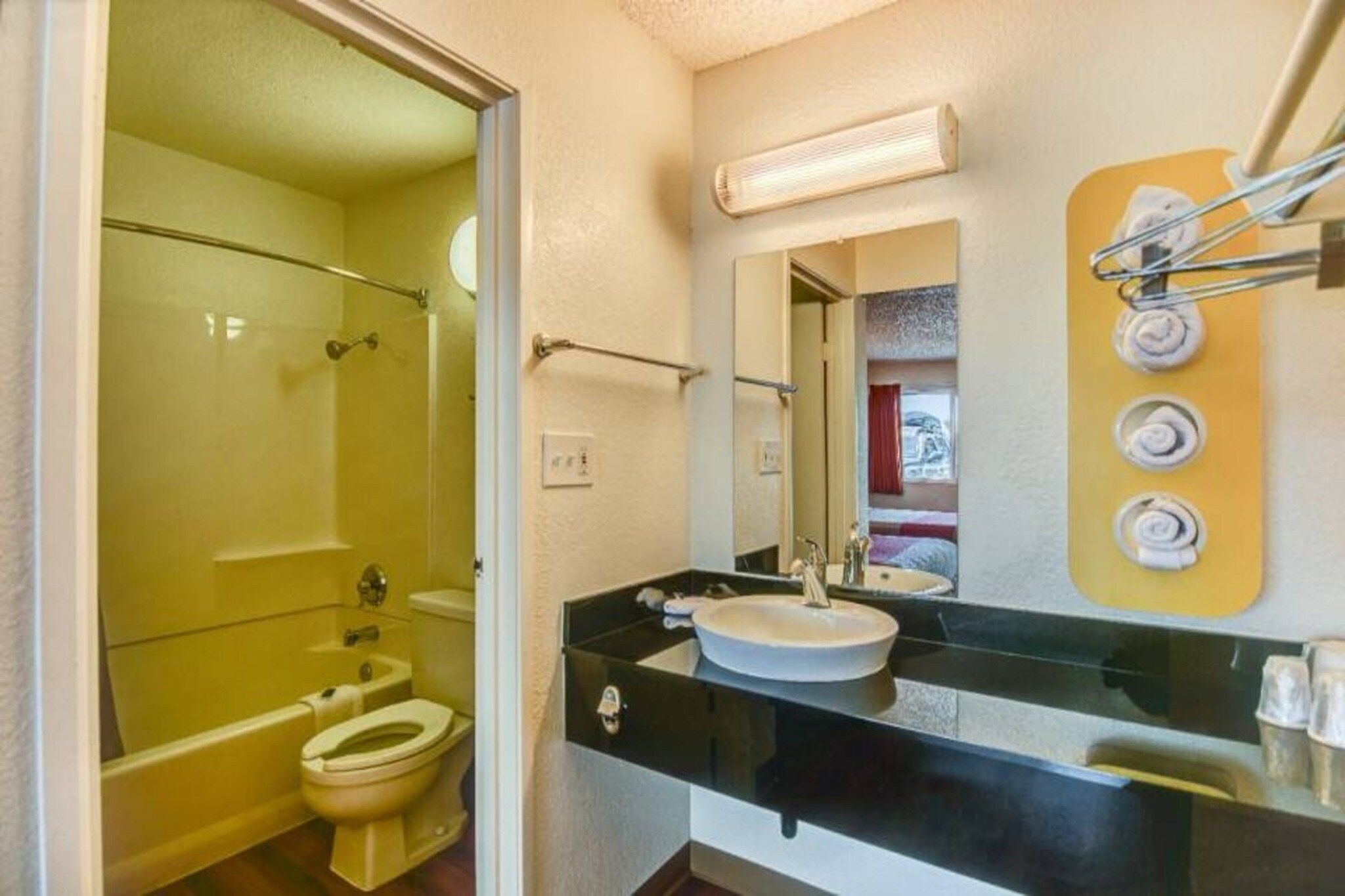 A bathroom with a toilet, a sink, and a glass-enclosed shower.