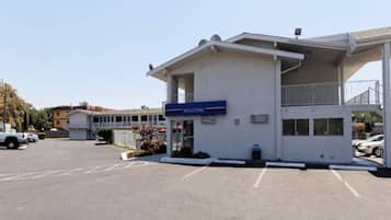 A building with a 'WELCOME' sign, a covered entrance, and a parking lot.