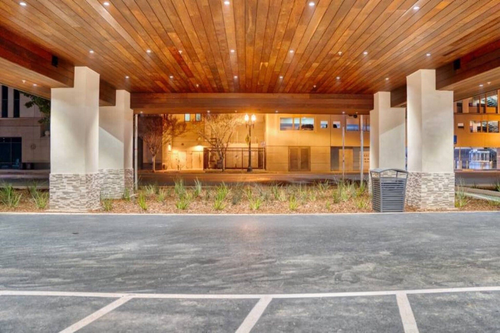 A building with a wooden ceiling and a paved entrance area.