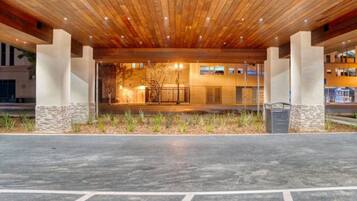 A building with a wooden ceiling and a paved entrance area.