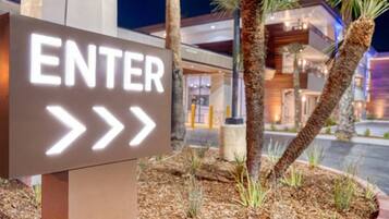 A sign with the word 'ENTER' and directional arrows pointing to the right, indicating the entrance direction.