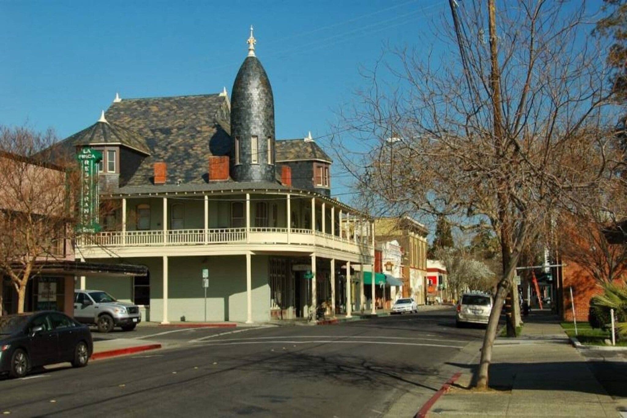 A building with a prominent tower and a balcony.